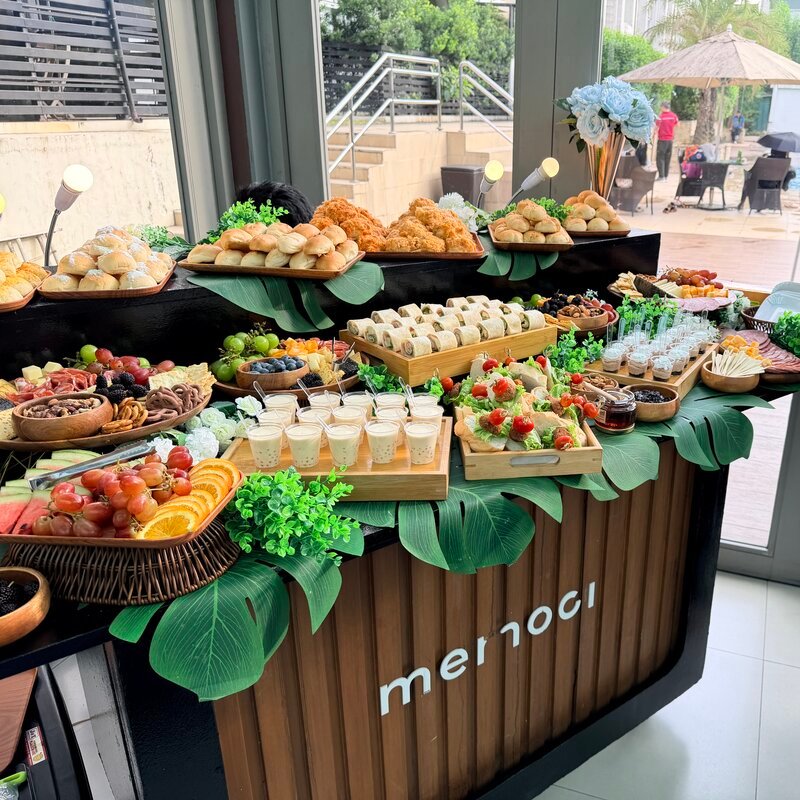 Grazing table spread with breads, charcuterie, and boba drinks